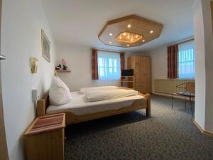 a bedroom with a bed in a room at Haus Steinacher in Hopferau +16 photos