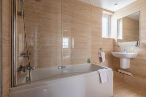 a bathroom with a tub and a sink at St Albans Lower - Elie in Earlsferry +21 photos