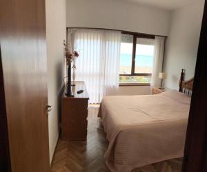 a hotel room with a bed and a window at Amanecer del Mar in Necochea