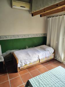 En eller flere senge i et værelse på Casa Alto Alberdi