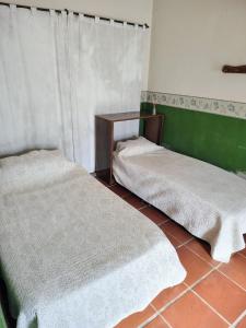 En eller flere senge i et værelse på Casa Alto Alberdi + 4 billeder