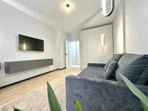 a living room with a couch and a flat screen tv at Central Park Apart Irpin in Irpin