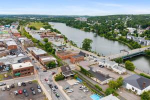 an aerial view of a town next to a river at Golden Hour @TheMillRowsSuites in New Glasgow