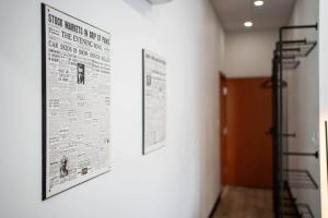 a wall with a poster on a wall with a ladder at The Classic @TheMillRowsSuites in New Glasgow