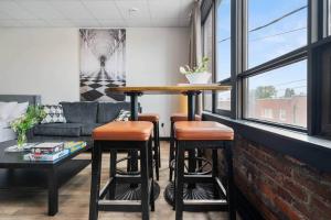 a living room with a bar and a couch at Game Night @ The MillRows Suites in New Glasgow +16 photos