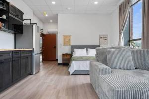 a living room with a couch and a bed at The Library @TheMillRowsSuites in New Glasgow +9 photos