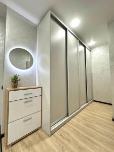 a room with a closet with a dresser and a mirror at Central Park Apart Irpin in Irpin