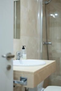 a bathroom with a sink and a shower at Apartamentos Océanos in Málaga +15 photos