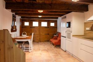 a kitchen with a table and a dining room at Casa Rural Dauden 3 Habitaciones in Cantavieja