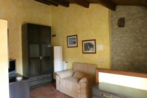 a living room with a couch and a tv at Casa Rural Dauden 3 Habitaciones in Cantavieja