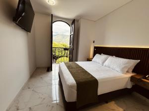 En eller flere senge i et værelse på Hotel Casa Volga