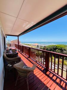 a balcony with chairs and a view of the ocean at 360onSea in De Kelders