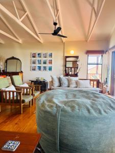 a living room with a large bed and a couch at 360onSea in De Kelders