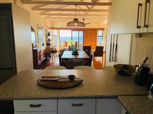 a kitchen with a counter top with a table in it at 360onSea in De Kelders +42 photos
