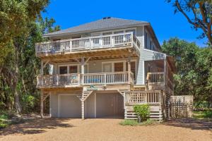 a large house with a balcony and a garage at 2002 - Hidden Aweigh in Sanderling