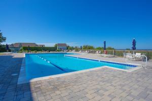 a swimming pool with blue water in a yard at 2002 - Hidden Aweigh in Sanderling