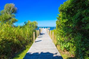 a wooden pathway leading to the ocean on a beach at 2002 - Hidden Aweigh in Sanderling