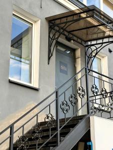 a balcony of a house with a window at Insula Poilsio Namai in Telšiai +3 photos