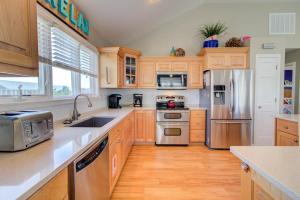 een keuken met houten kasten en roestvrijstalen apparatuur bij 1676 - Good Humor in Corolla