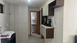 a small kitchen with a sink and a counter top at Cantinho do Sossego in João Pessoa
