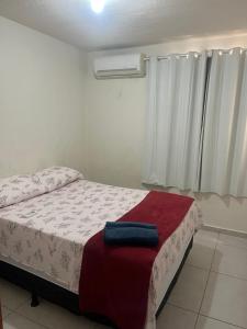 a small bedroom with a bed and a window at Cantinho do Sossego in João Pessoa
