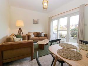 a living room with a couch and a table at Tram Lane Cottage in Carnforth