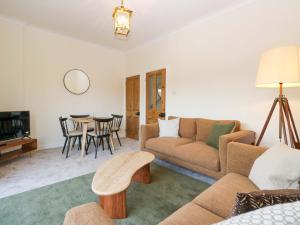 a living room with a couch and a table at Tram Lane Cottage in Carnforth