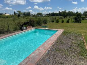 a swimming pool in the backyard of a house at La casita de Isa in Gualeguay