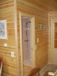 a bathroom with a shower in a wooden wall at Les Rochettes Pluton 3 in La Roche-en-Ardenne