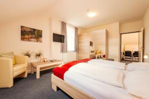 a hotel room with a large bed and a couch at Das Karl August in Fohnsdorf +65 photos