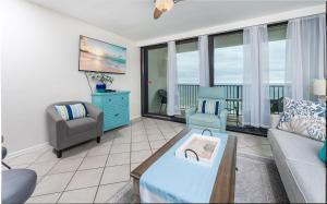 a living room with a couch and a chair at Island Winds West 777 in Gulf Shores