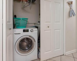 a washer and dryer in a kitchen with a door at Island Winds West 777 in Gulf Shores +43 photos