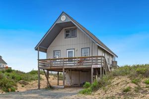 a house sitting on top of a hill at 4060 - Foxhole in Kitty Hawk Beach
