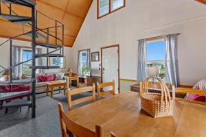 a dining room and living room with a loft bed and a table at 4060 - Foxhole in Kitty Hawk Beach +21 photos