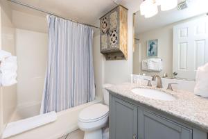 a bathroom with a toilet and a sink and a shower at Island Winds West 777 in Gulf Shores