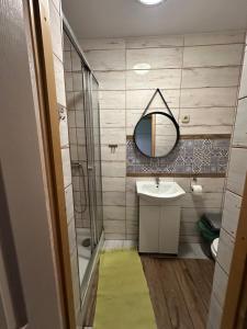 a bathroom with a sink and a shower and a mirror at Pod Kasztanem in Wisła +62 photos