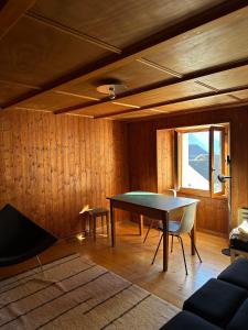 a dining room with a ping pong table and chairs at Waterfall House - Art and Design, Ski, Hike, Swim in Mesocco