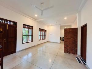 a large room with white walls and a brick wall at Riverside Serenity in Talpe