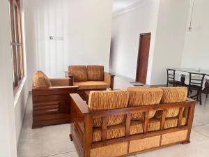 a living room with a couch and chairs and a table at Riverside Serenity in Talpe