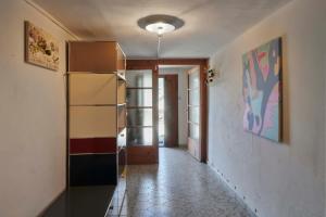 a hallway with a shelf in a room at Waterfall House - Art and Design, Ski, Hike, Swim in Mesocco