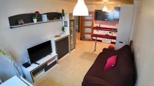 ein Wohnzimmer mit Sofa und eine Küche in der Unterkunft Apartalux Clara Campoamor in Carboneras + 28 Fotos