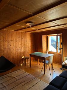a dining room with a ping pong table and chairs at Waterfall House - Art and Design, Ski, Hike, Swim in Mesocco