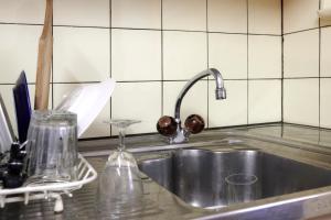 a kitchen sink with a faucet on top of it at Waterfall House - Art and Design, Ski, Hike, Swim in Mesocco +57 photos