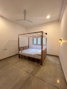 a bedroom with a bed with a mosquito net at Riverside Serenity in Talpe