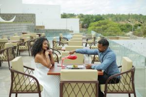 a bride and groom sitting at a table on the roof at Ricefield Valley in Mandriankeniheny
