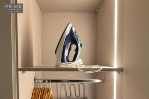 a blue and white appliance sitting on a shelf in a refrigerator at Prime Residence Zayed Heights in Sheikh Zayed