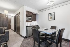 a kitchen and dining room with a table and chairs at Lift House Lodge, Pet Friendly, Premium Studio Condo in Vail