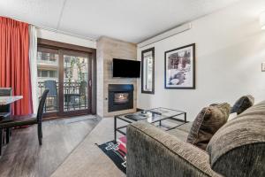 a living room with a couch and a fireplace at Lift House Lodge, Pet Friendly, Premium Studio Condo in Vail