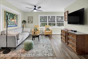 a living room with a couch and a flat screen tv at Safety Harbor Motel in Safety Harbor