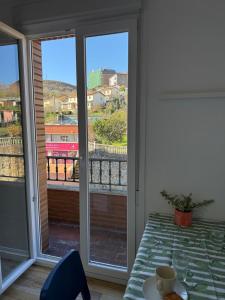 a room with a table and a window with a view at Gran Bilbao LaGa Apartamentos in Basauri